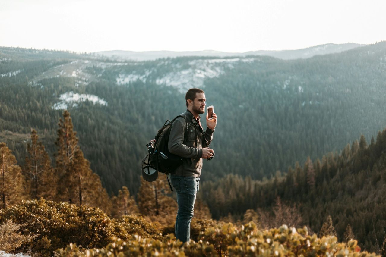 Man Using Phone Outside While Hiking